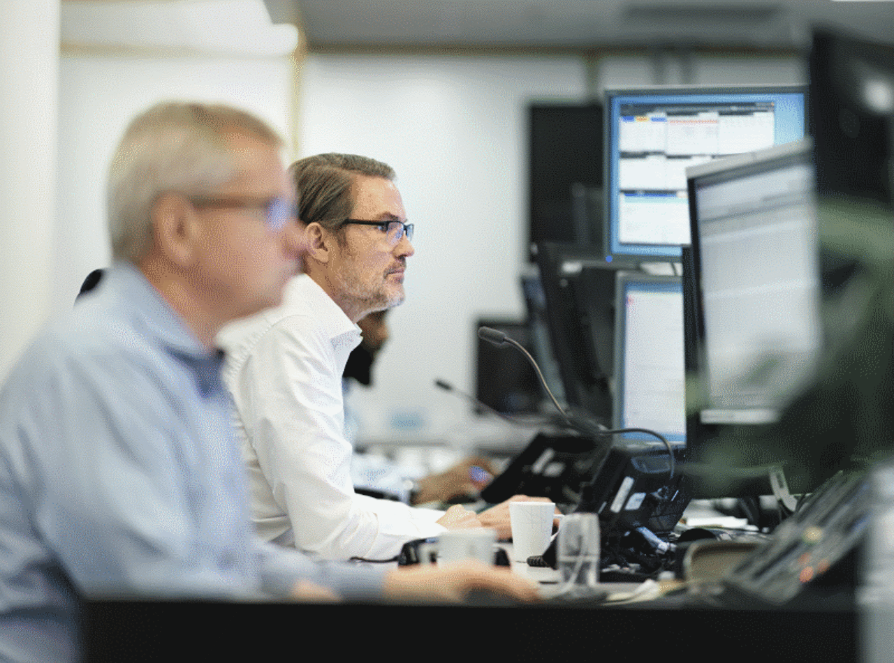 Two men working at their computers